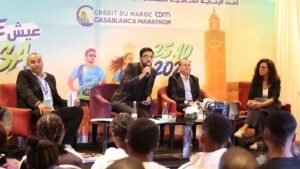 Five panelists seated on stage during Casablanca Marathon press conference with audience