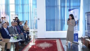مسؤولة تتحدث أمام حضور رسمي بمناسبة إطلاق خدمة جديدة للتقاعد