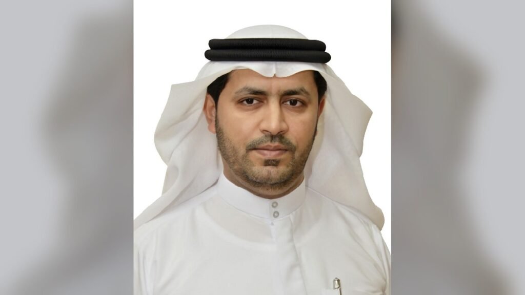 Formal portrait of man in white thobe and black headwear