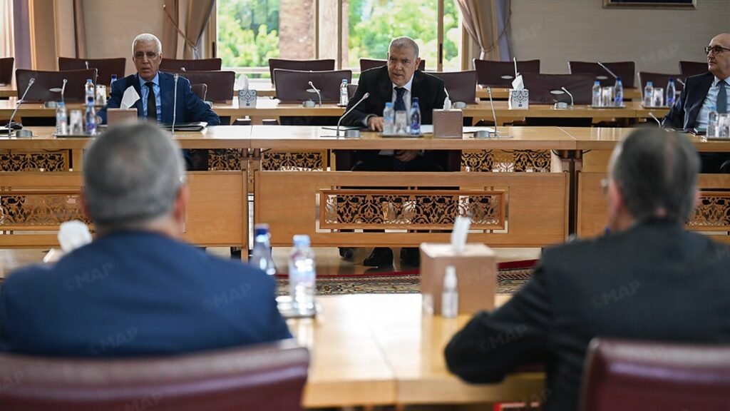 Official meeting session with multiple political party representatives and leaders seated