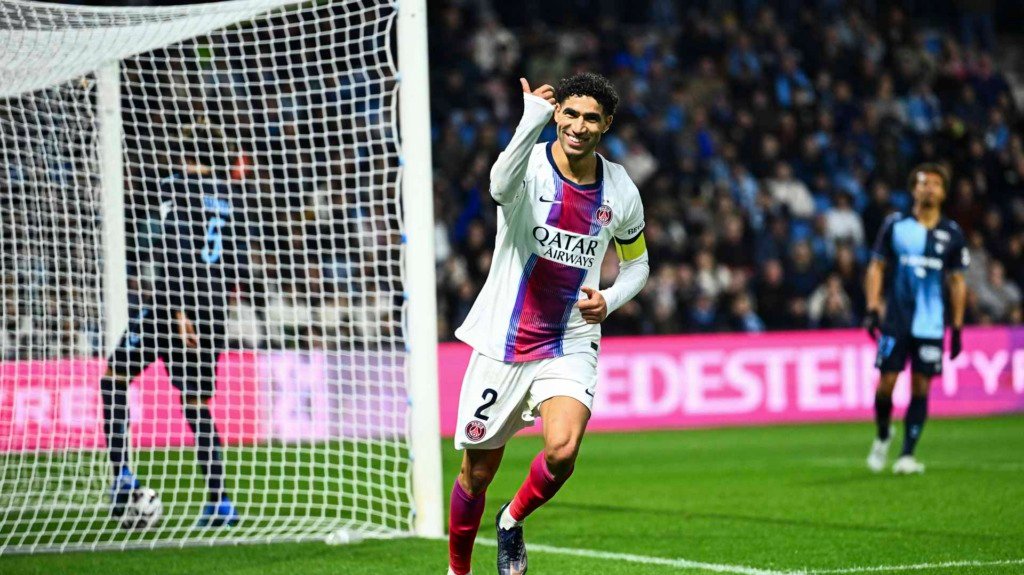 PSG player in white jersey celebrates goal at stadium