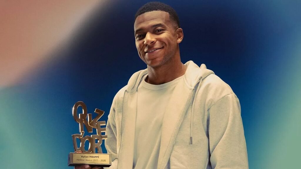Smiling player holding bronze trophy at awards ceremony with blue backdrop