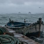 Traditional fishing boat moored at Safi port amid rough seas